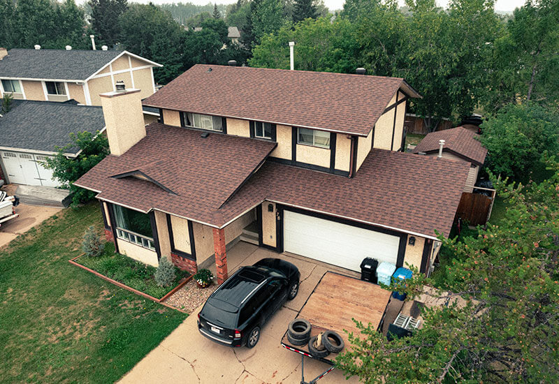 Residential home with a well-maintained roof and landscaped yard Residential home with a well-maintained roof and landscaped yard